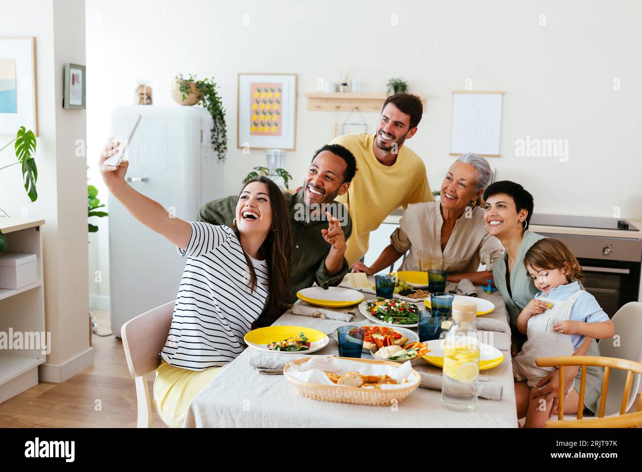 Family sitting at dining table hi-res stock photography and images - Alamy