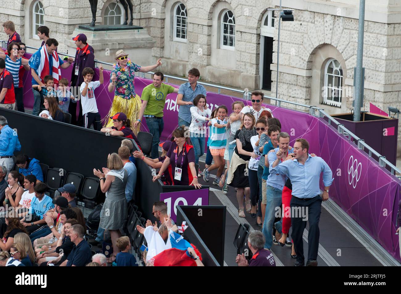 Spectators doing a conga line during an intermission at beach
