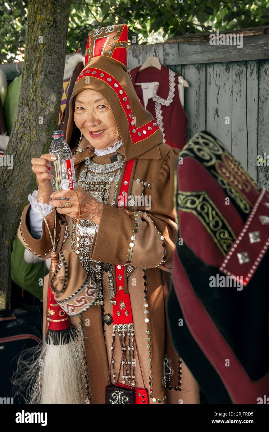 Kolomna, Russia, 12 June 2022. Celebration of the Day of Russia. An elderly Yakut woman in national costume holding a bottle of water. An elderly Yaku Stock Photo