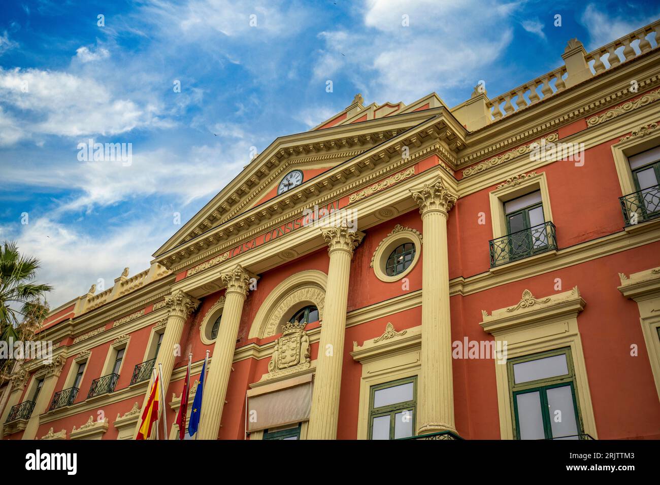 Facade of the Town Hall of Murcia, Spain with salmon colours, columns ...