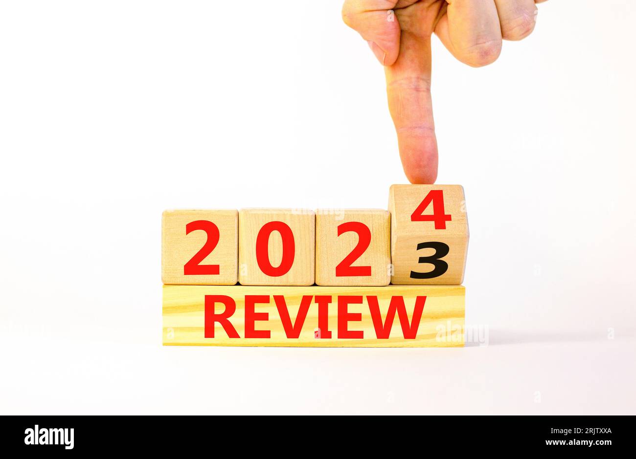 2025 review new year symbol. Businessman turns a wooden cube and