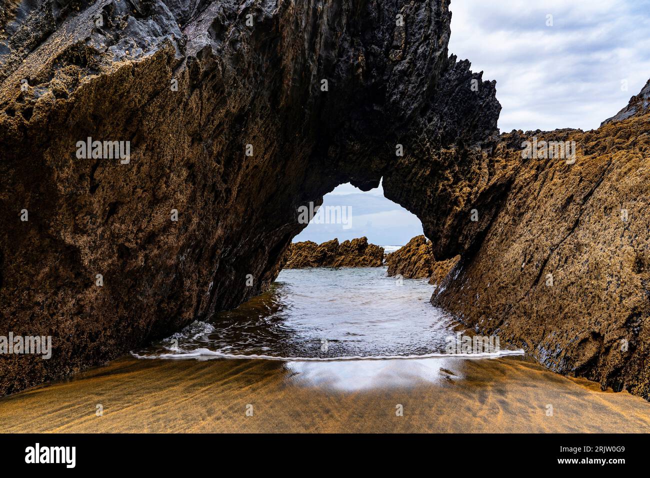 Natural archway, Playa de Otur, Asturias - Otur beach part of the Protected Landscape of the Western Coast of Asturias, Spain. Stock Photo