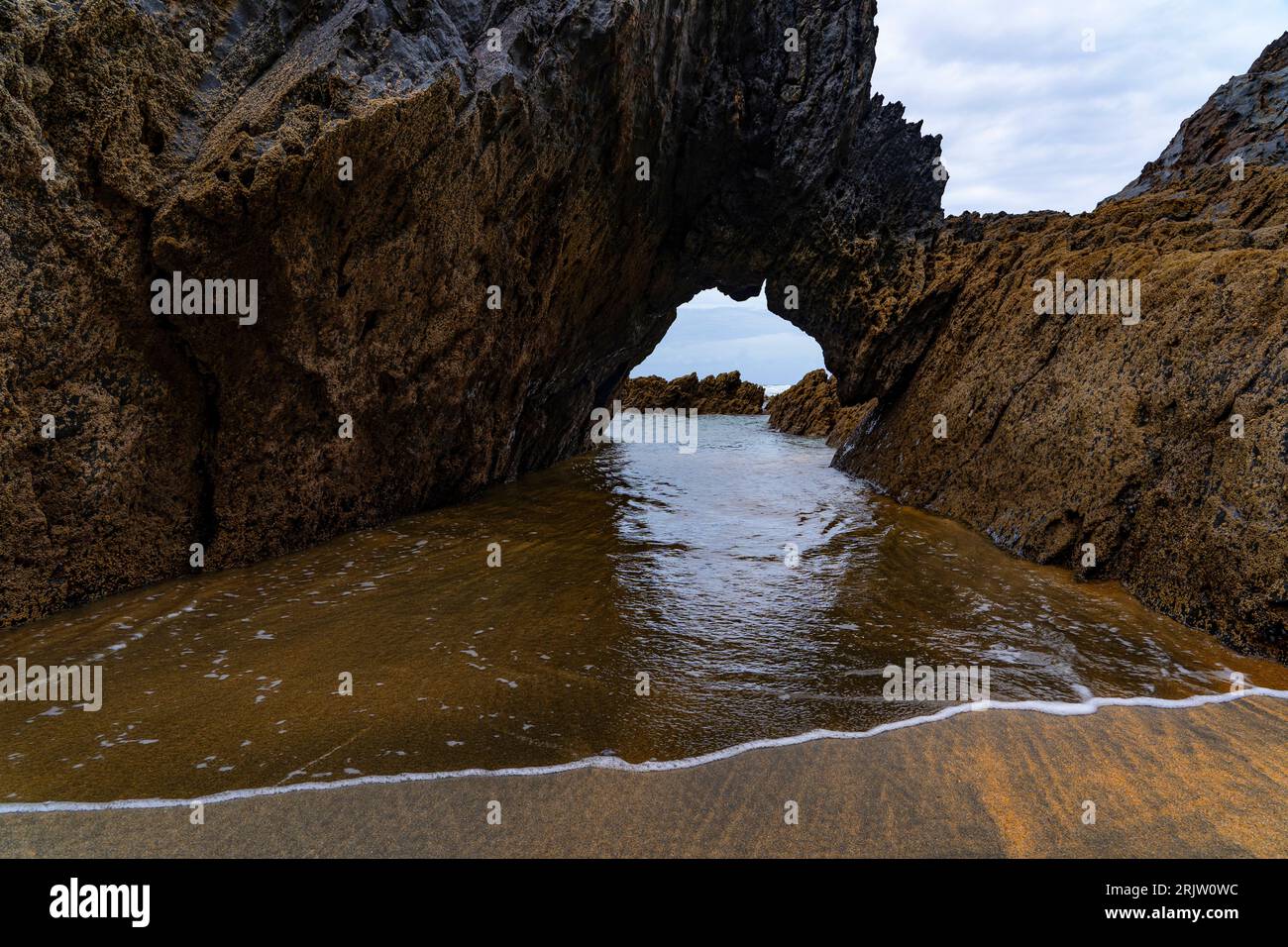 Natural archway, Playa de Otur, Asturias - Otur beach part of the Protected Landscape of the Western Coast of Asturias, Spain. Stock Photo