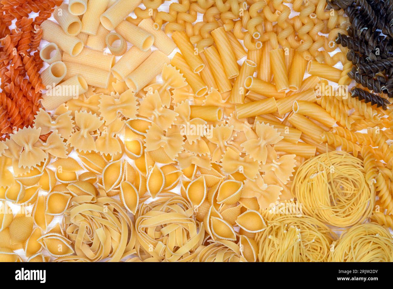 Types of Pasta - Rigatoni, Spirali, Farfalle, Tagliatelle, Tricolore Fusilli and Vermicelli. Stock Photo