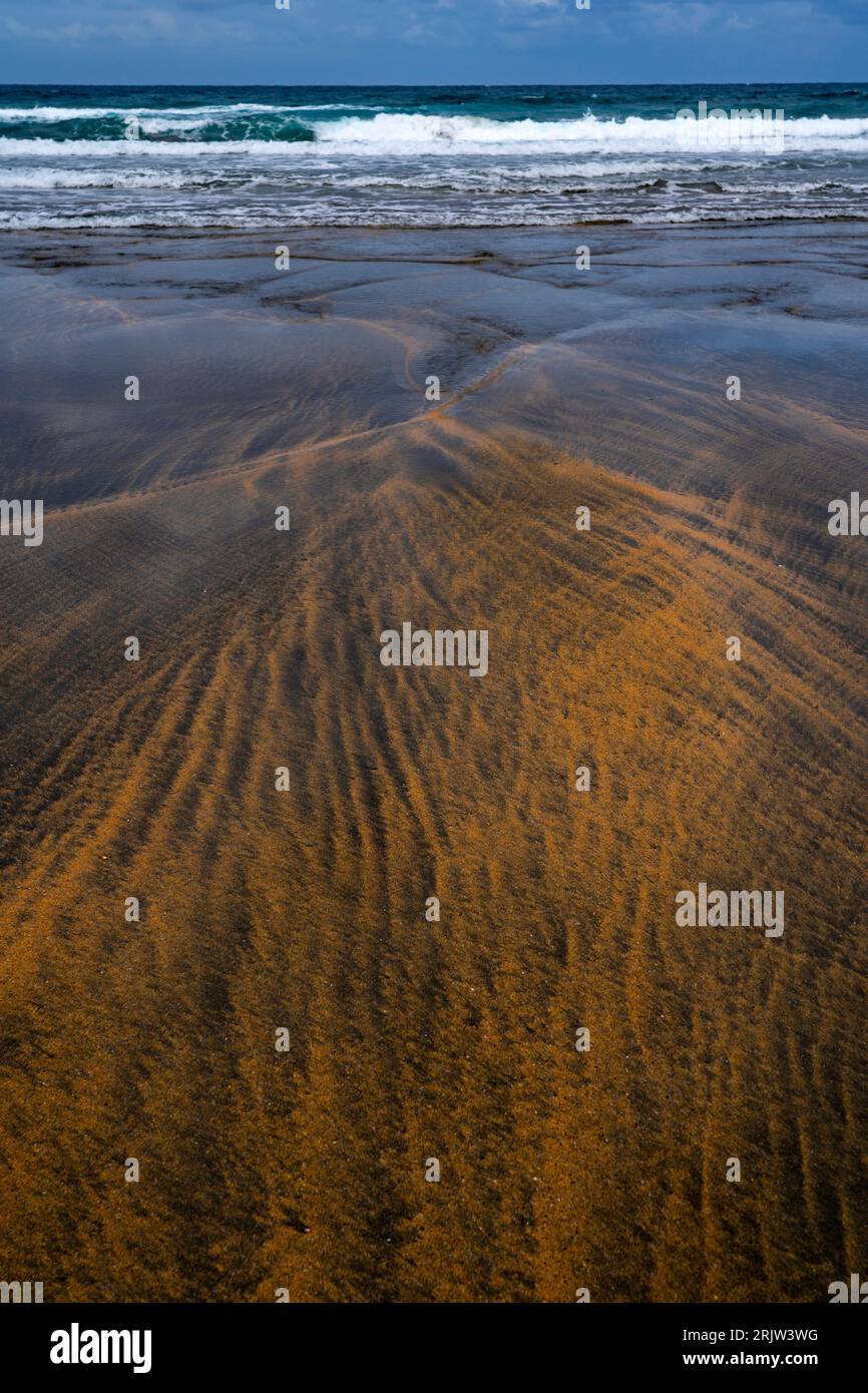 Black and gold sand on Playa de Otur, Asturias - Otur beach part of the Protected Landscape of the Western Coast of Asturias, Spain. Stock Photo