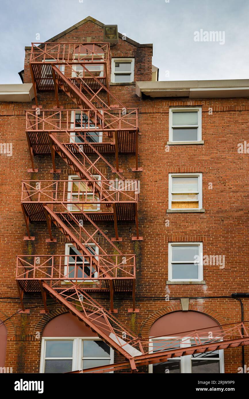 Outside fire escape on the side of an abandoned brick building. Stock Photo