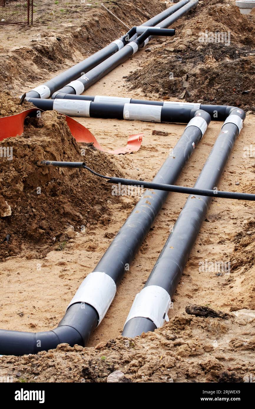 Pipes for heating water in the ground close up Stock Photo Alamy