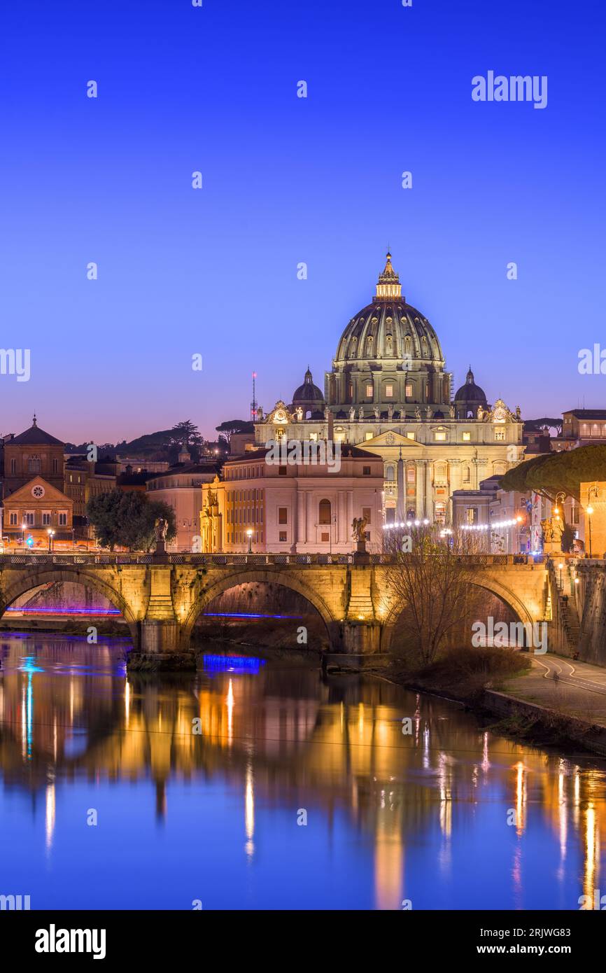 St. Peter's Basilica in Vatican City with the Tiber River passing through Rome, Italy at dusk. Stock Photo