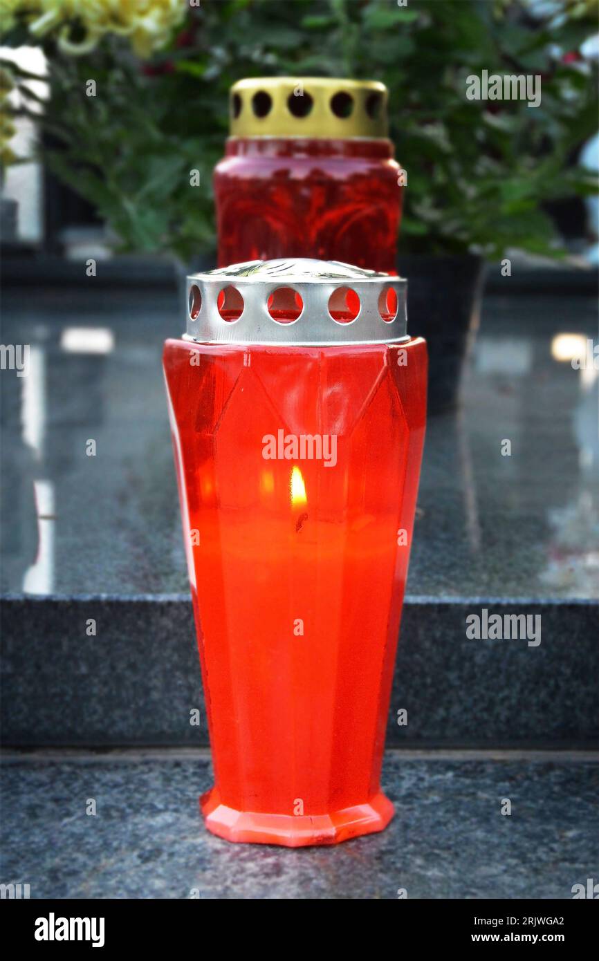Votive candle burning on the grave Stock Photo Alamy