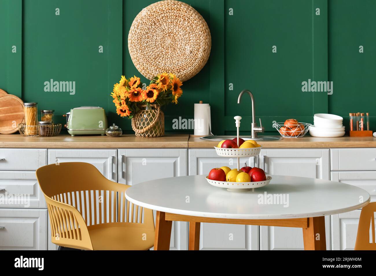 Interior of modern kitchen with white counters and dining table Stock ...