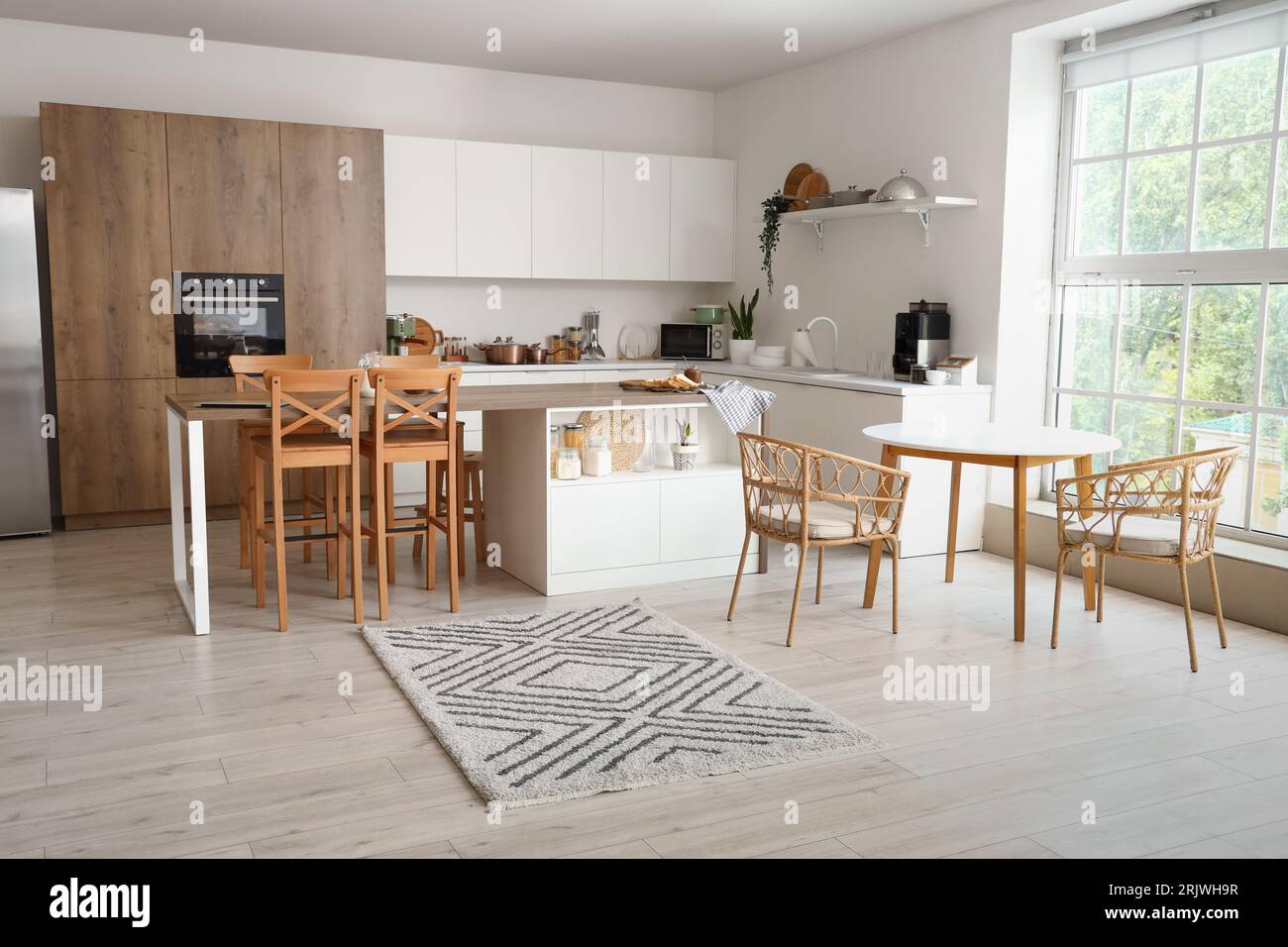 Interior of modern kitchen with counters and tables Stock Photo - Alamy