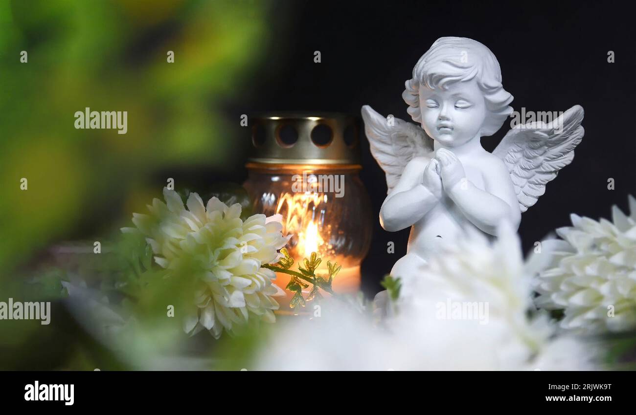Condolence card with funeral candle, angel and flower Stock Photo