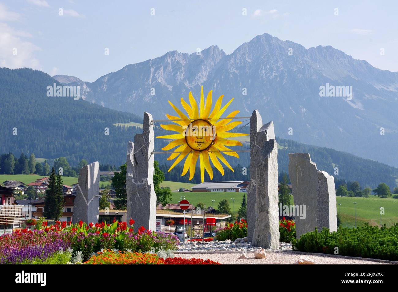 Söll, Austria, Sun Symbol with Mountains Behind. Stock Photo