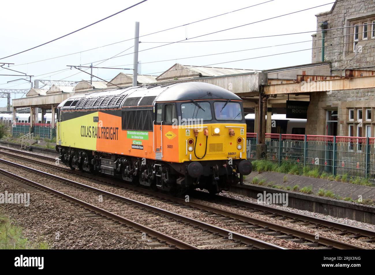 Green Fuel class 56 grid diesel-electric loco in Colas Rail Freight orange and yellow livery on West Coast Main Line, Carnforth, 23rd August 2023. Stock Photo