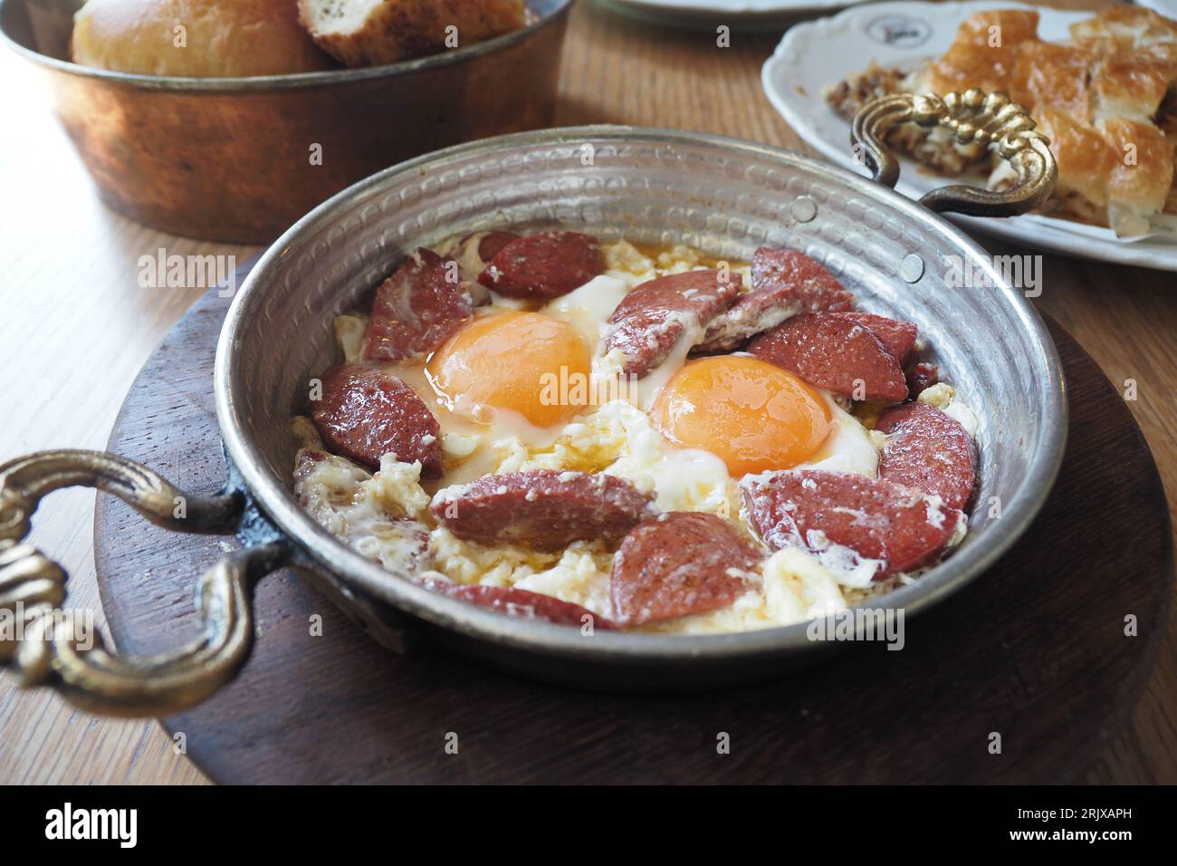 Turkish scrambled sausage eggs in copper pan Stock Photo Alamy