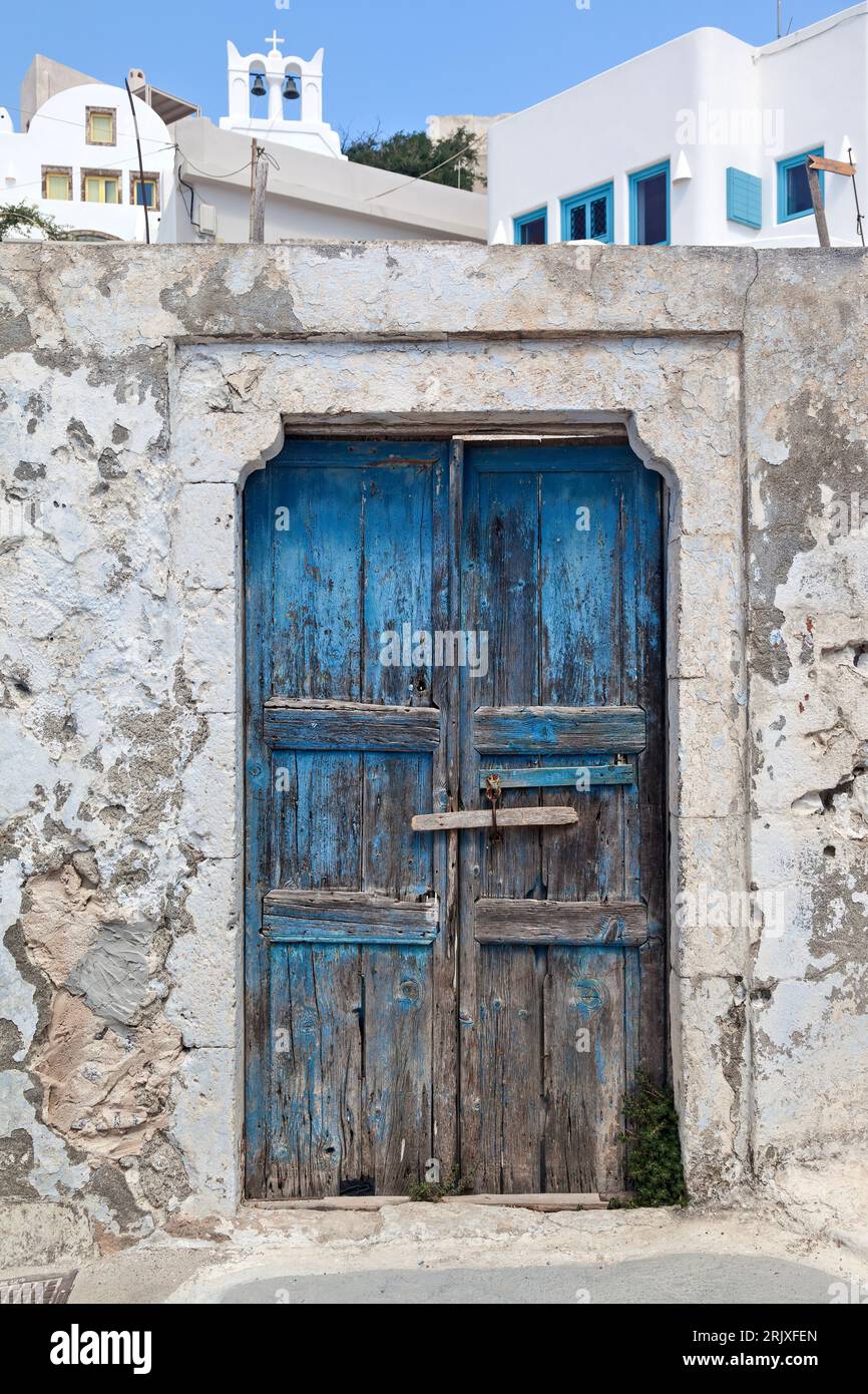 Old wooden door of an abandoned traditional house at the picturesque village of Pyrgos Kallistis, in Santorini, Cyclades islands, Greece, Europe. Stock Photo