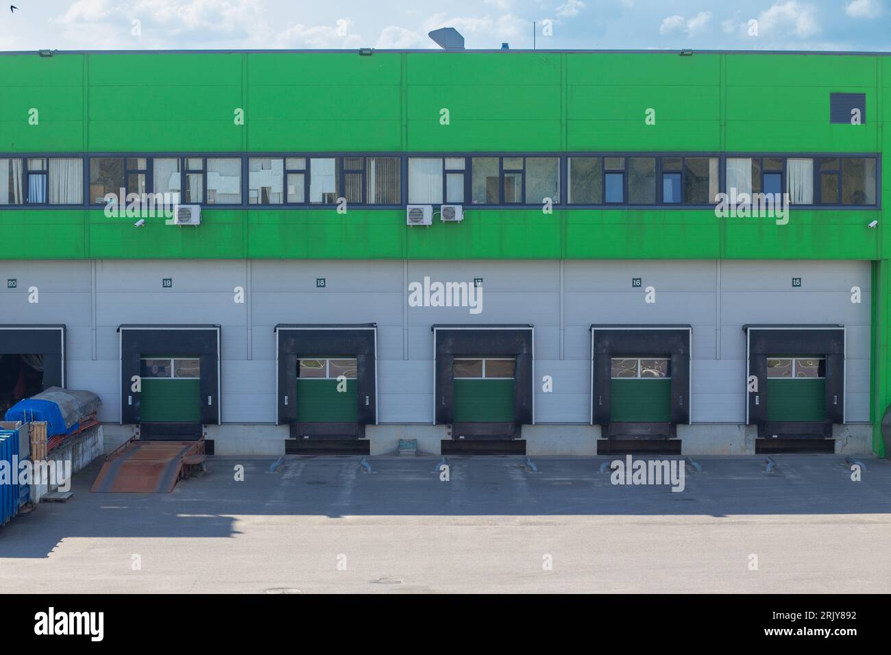 Row of loading docks with shutter doors. Warehouse gates for loading and unloading cargo in a distributed center. Loading and unloading areas for truc Stock Photo