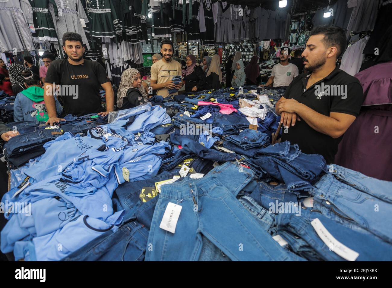 Palestinians seen shopping during the preparation for the new school year at the market in Gaza. Stock Photo