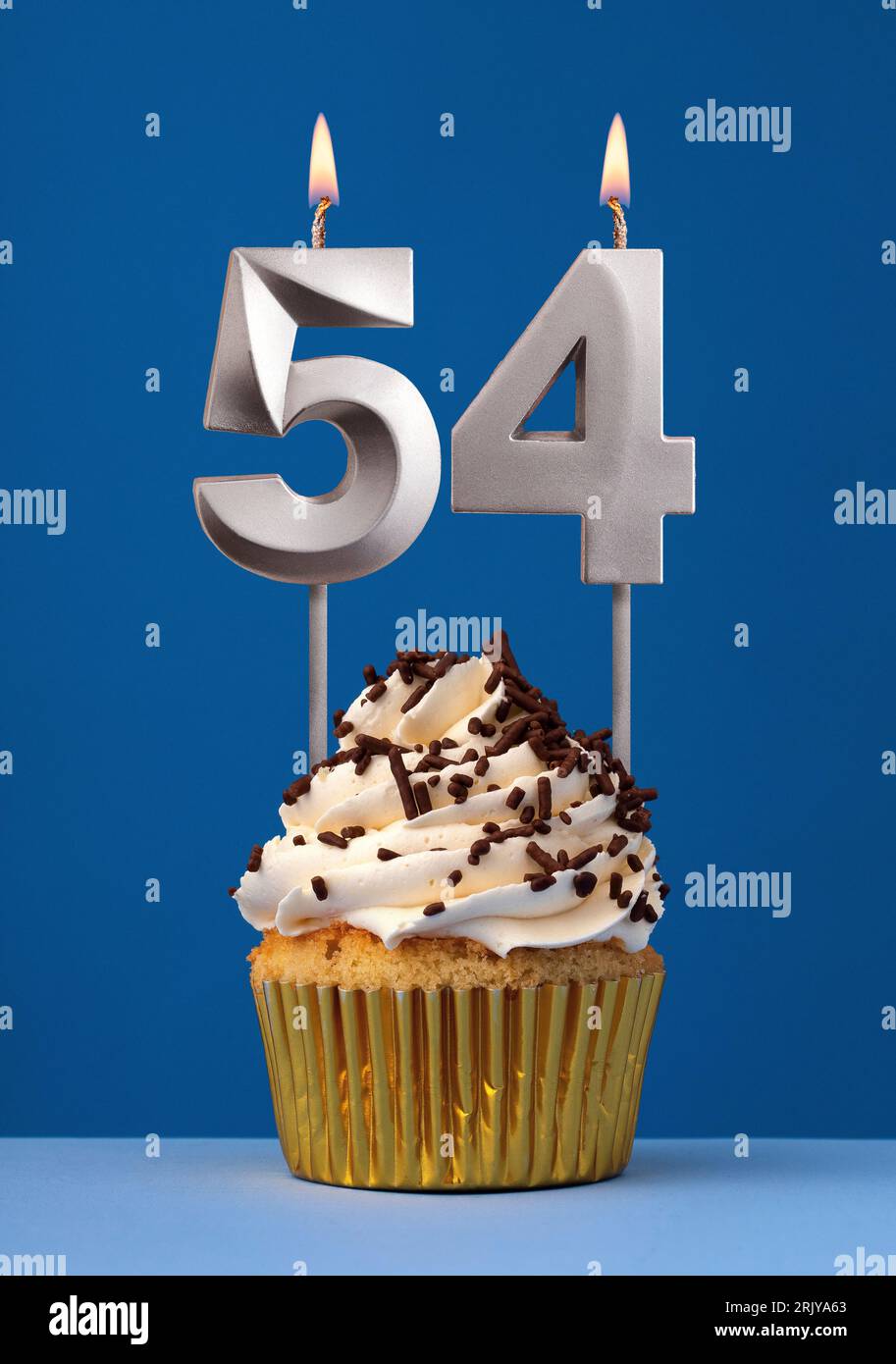 Vertical birthday card with cake - Lit candle number 54 on blue background Stock Photo