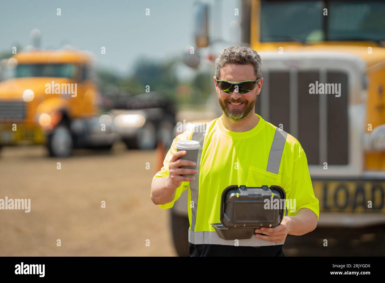 Man driver with lunch box. Truck driver having take away lunch drink