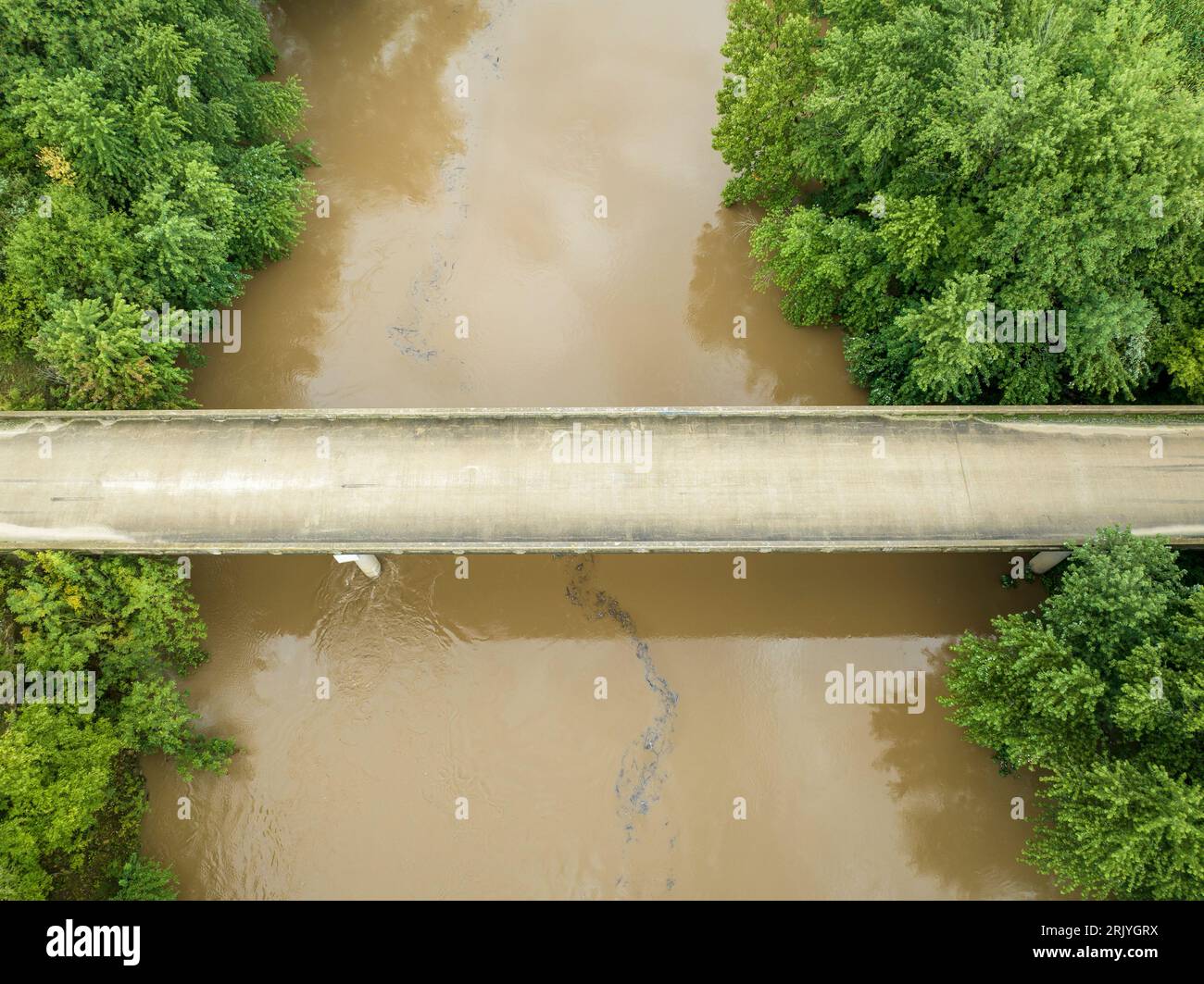 road and bridge over flooded Lamine River with floating debris, aerial view at Roberts Bluff access in Missouri Stock Photo