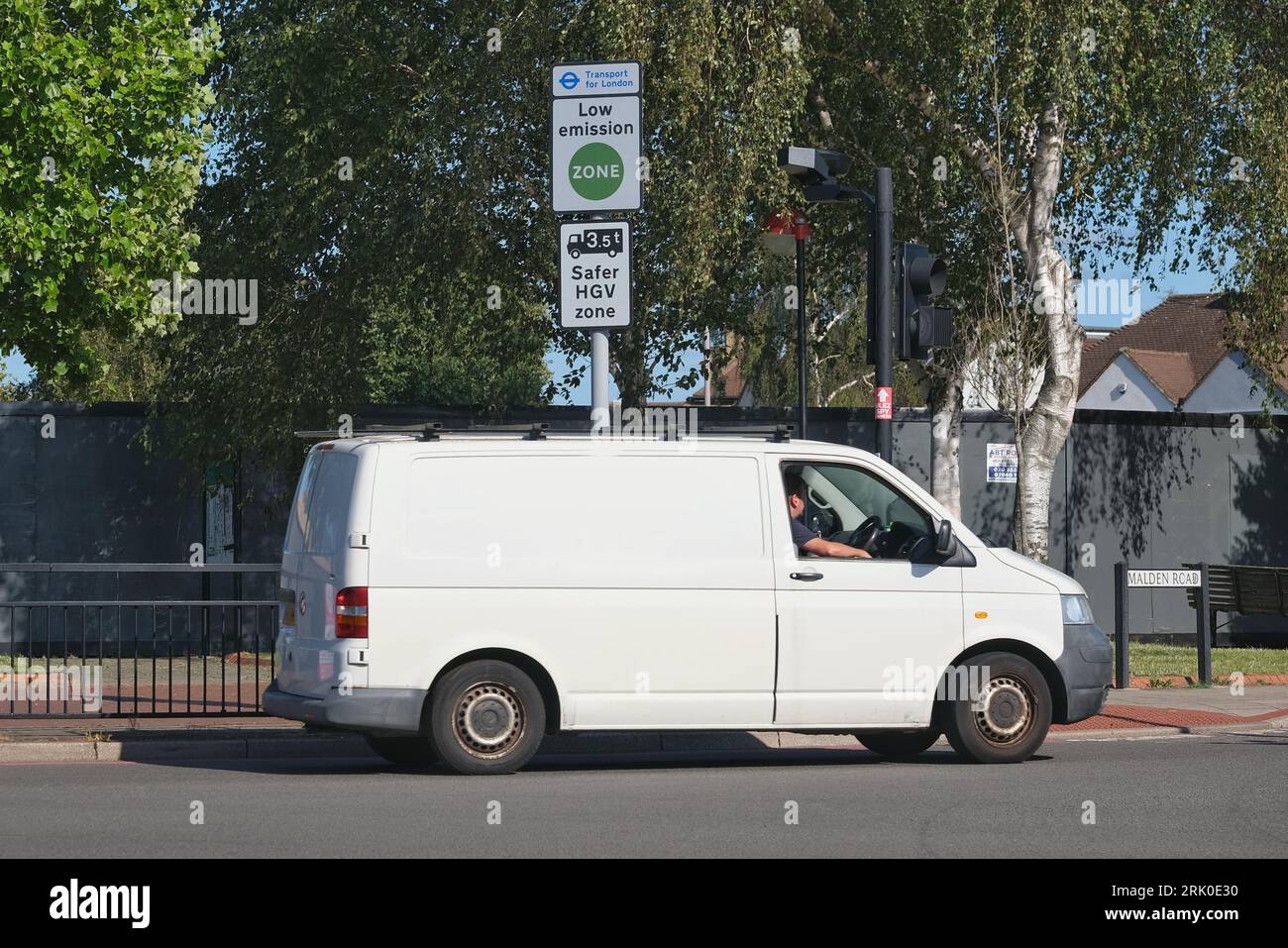 London, UK. A tradesperson's van passes a Low Emission Zone (LEZ) road sign in south-west London. Stock Photo
