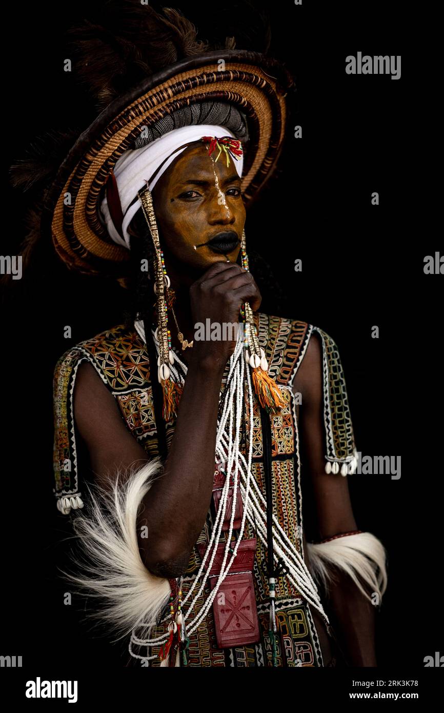 Dressed to impress and seduce women. Niger, Africa: STUNNING images show the Wodaabe men all painted and dressed up to seduce young women.One of the i Stock Photo