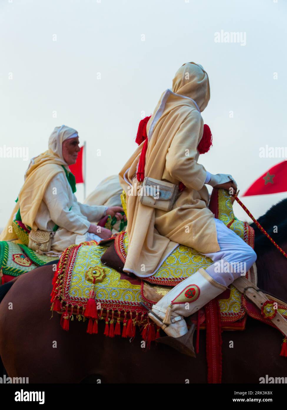 Essaouira, Morocco - 13 August 2023 : Equestrians participating in a traditional fancy dress event named Tbourida in Arabic dressed in a traditional M Stock Photo
