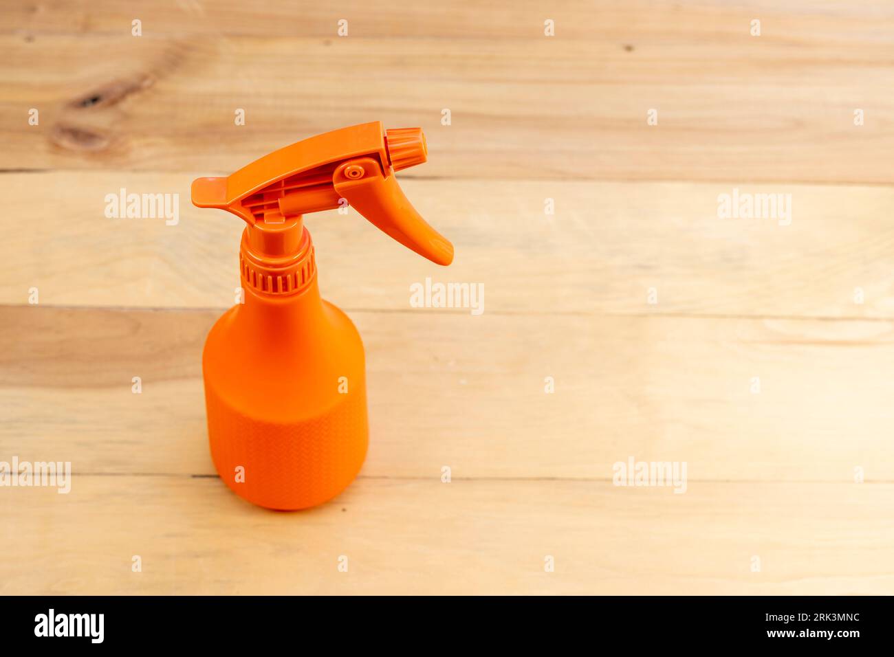 Sprayer bottle on wooden background with copy space Stock Photo