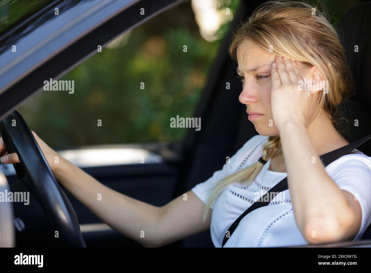 women with severe headache in her car Stock Photo Alamy