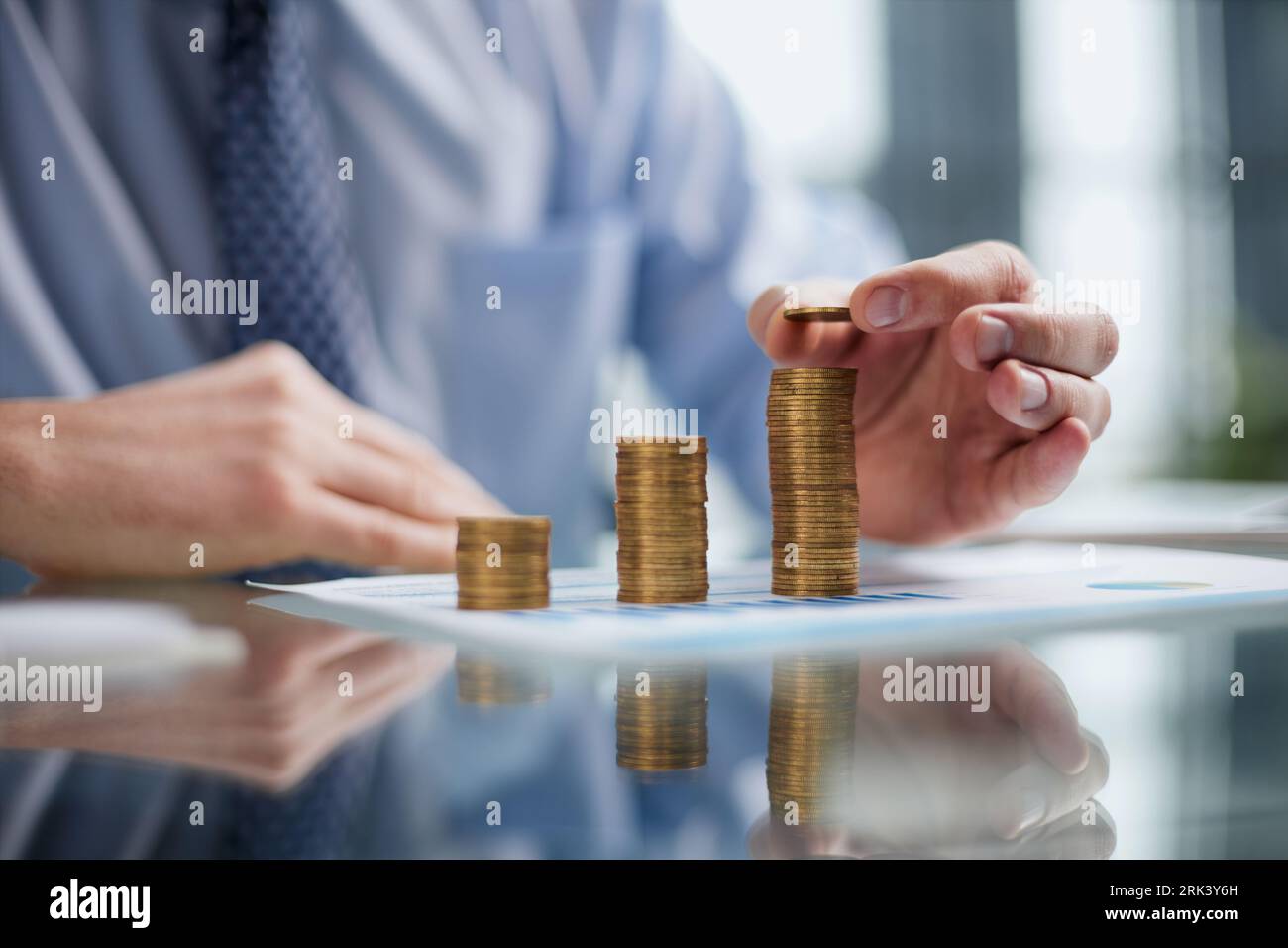 Businessman stacking coins on table, business growth concept. Hand puts ...