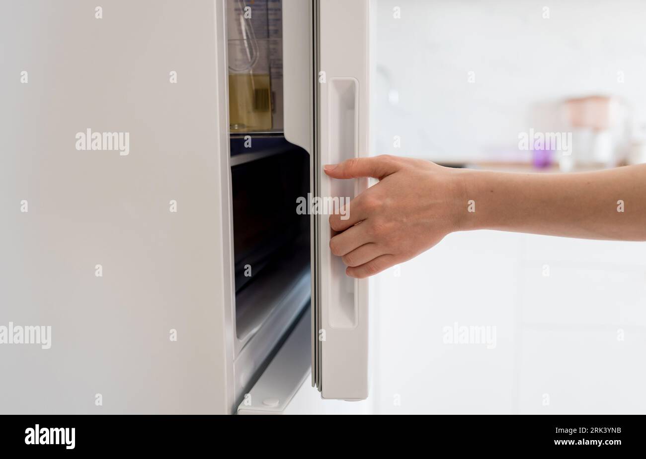 Female hand opening white refrigerator door Stock Photo Alamy