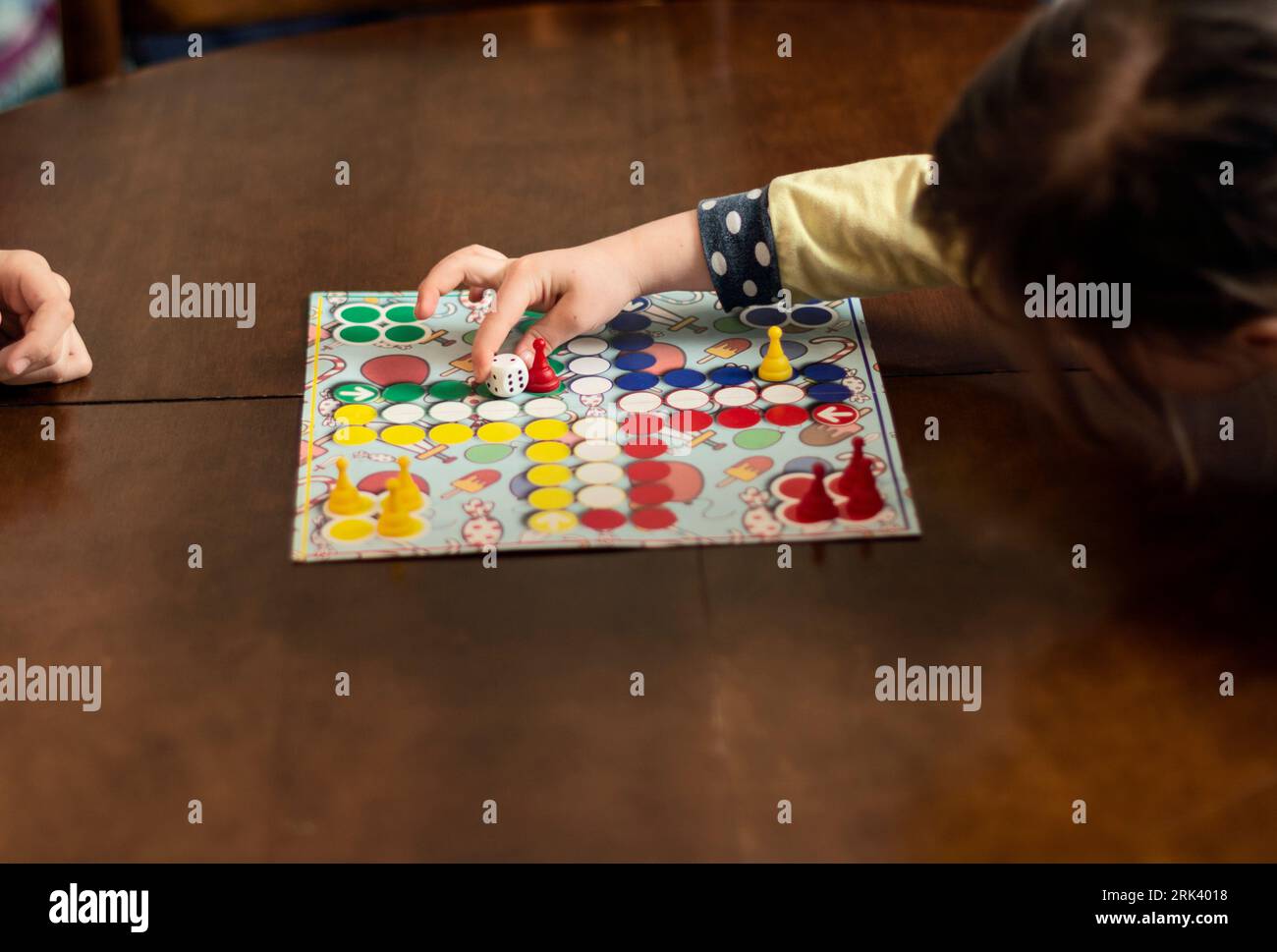 Close up of children playing board game in living room Stock Photo - Alamy