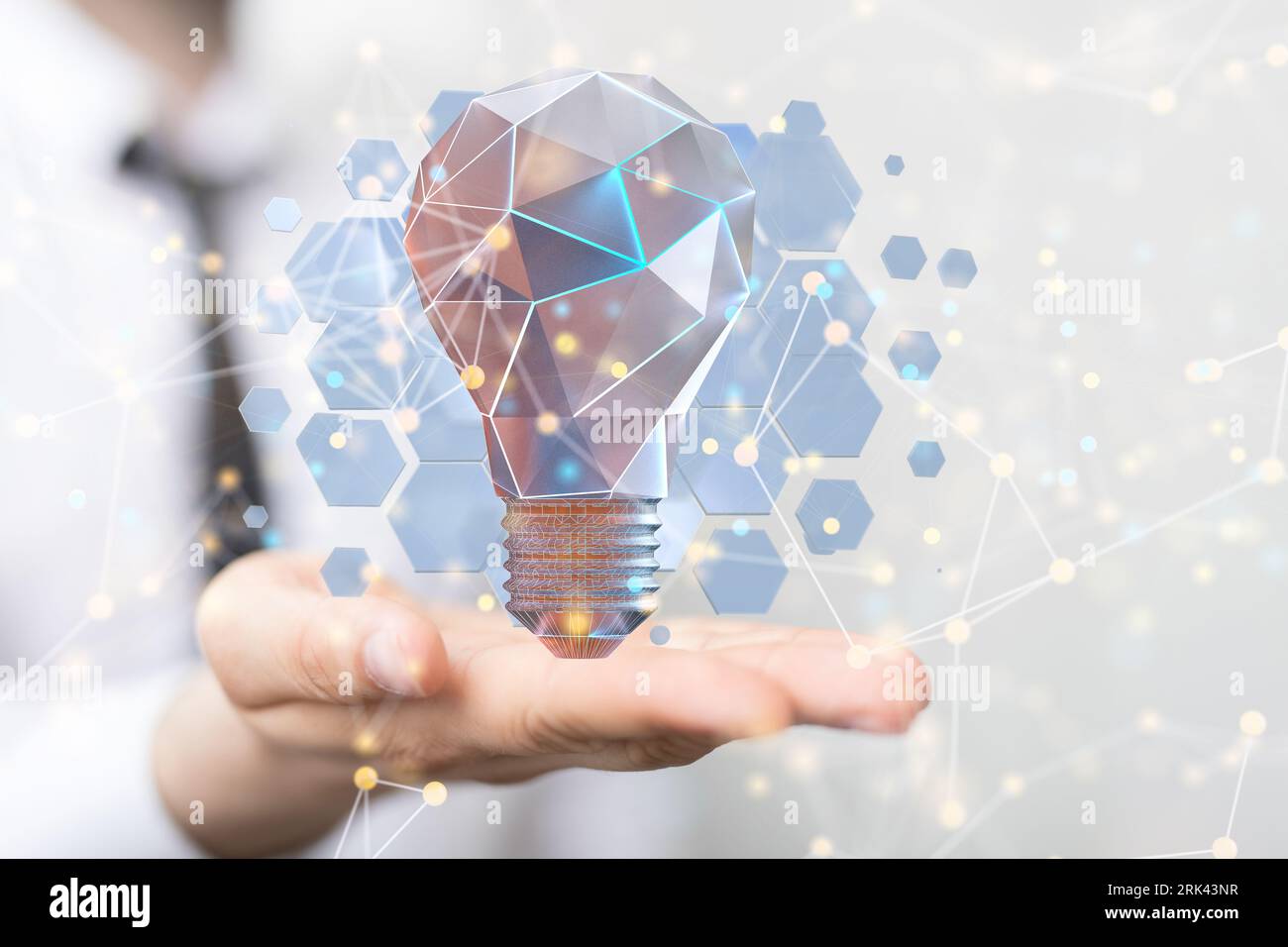 A man holding a glowing light bulb in his hand. the concept of new ideas Stock Photo