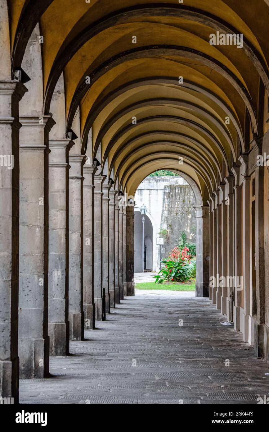 A majestic corridor featuring numerous grand arches and pillars crafted from stone Stock Photo