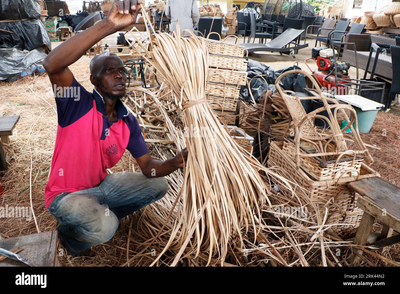 a-man-processes-cane-wood-for-weaving-at-nigeria-s-largest-cane