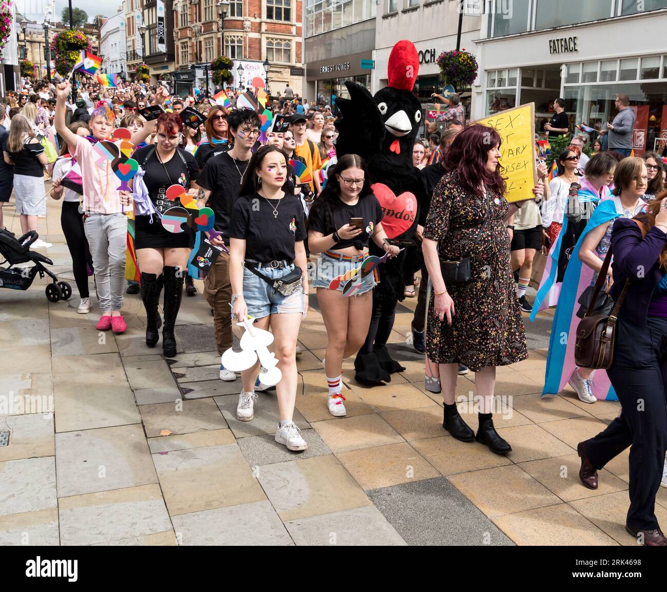People in Lincoln Pride Parade with Nando's black chicken, High Street