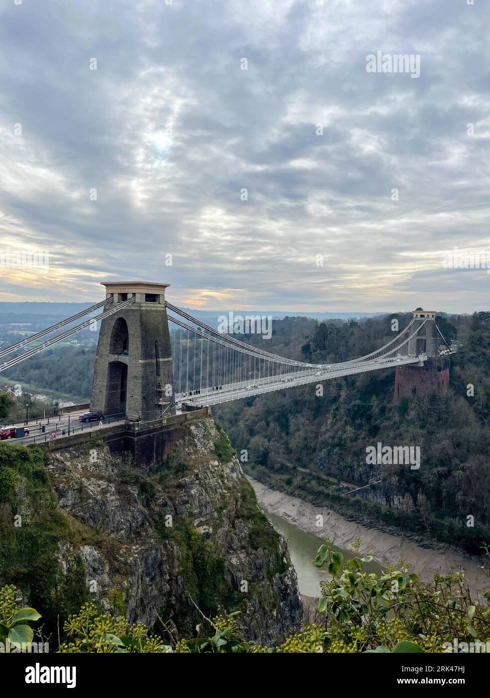 A stunning landscape featuring a suspension bridge spanning a river between hills and forests: Bristol suspension bridge Stock Photo
