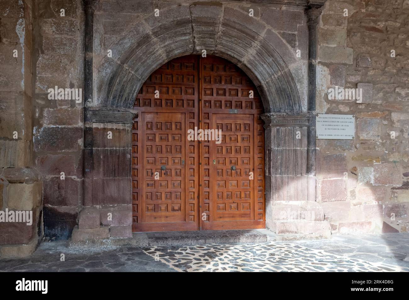 This stunning photograph captures the intricate details of the entrance door of Nuestra Señora de la Asunción, a beautiful church located in the charm Stock Photo