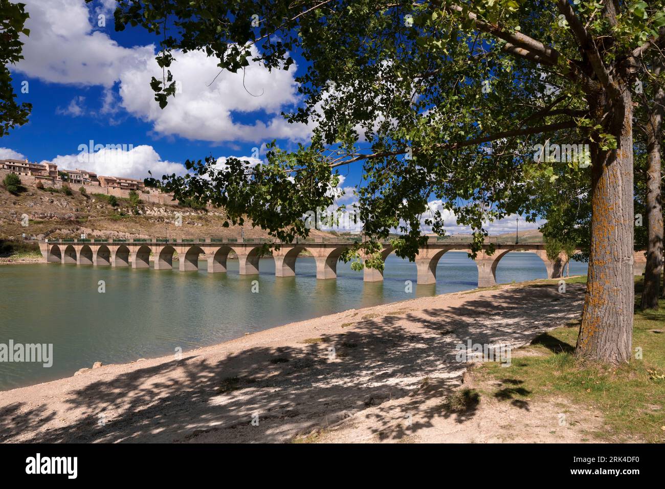 Immerse yourself in the breathtaking scenery of Segovia with this stunning photo of Linares Reservoir and the charming village of Maderuelo. Located i Stock Photo