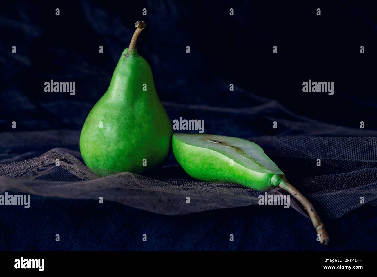 Green pears with vintage concept on a black background, close up, macro photography Stock Photo