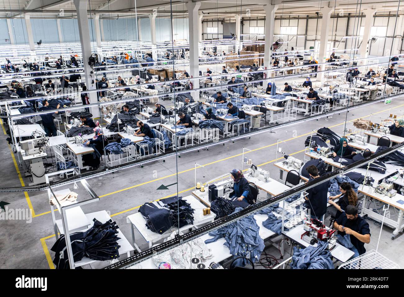 several sewing machines. Tailoring industry. jean making factory. jean