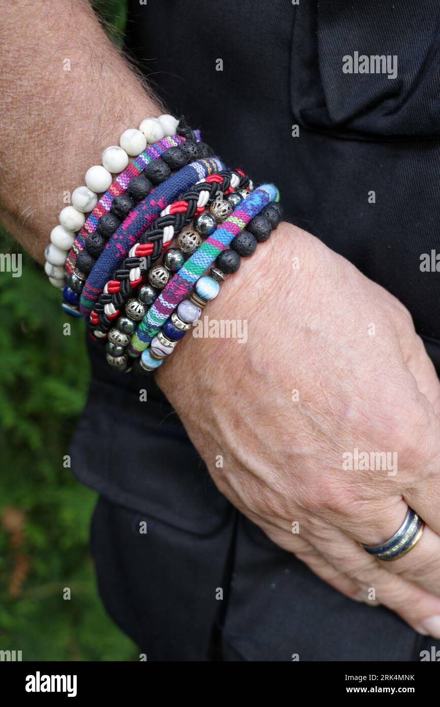 Male hand with a row of bracelets, breaded bracelets and ethnic hippie style Stock Photo