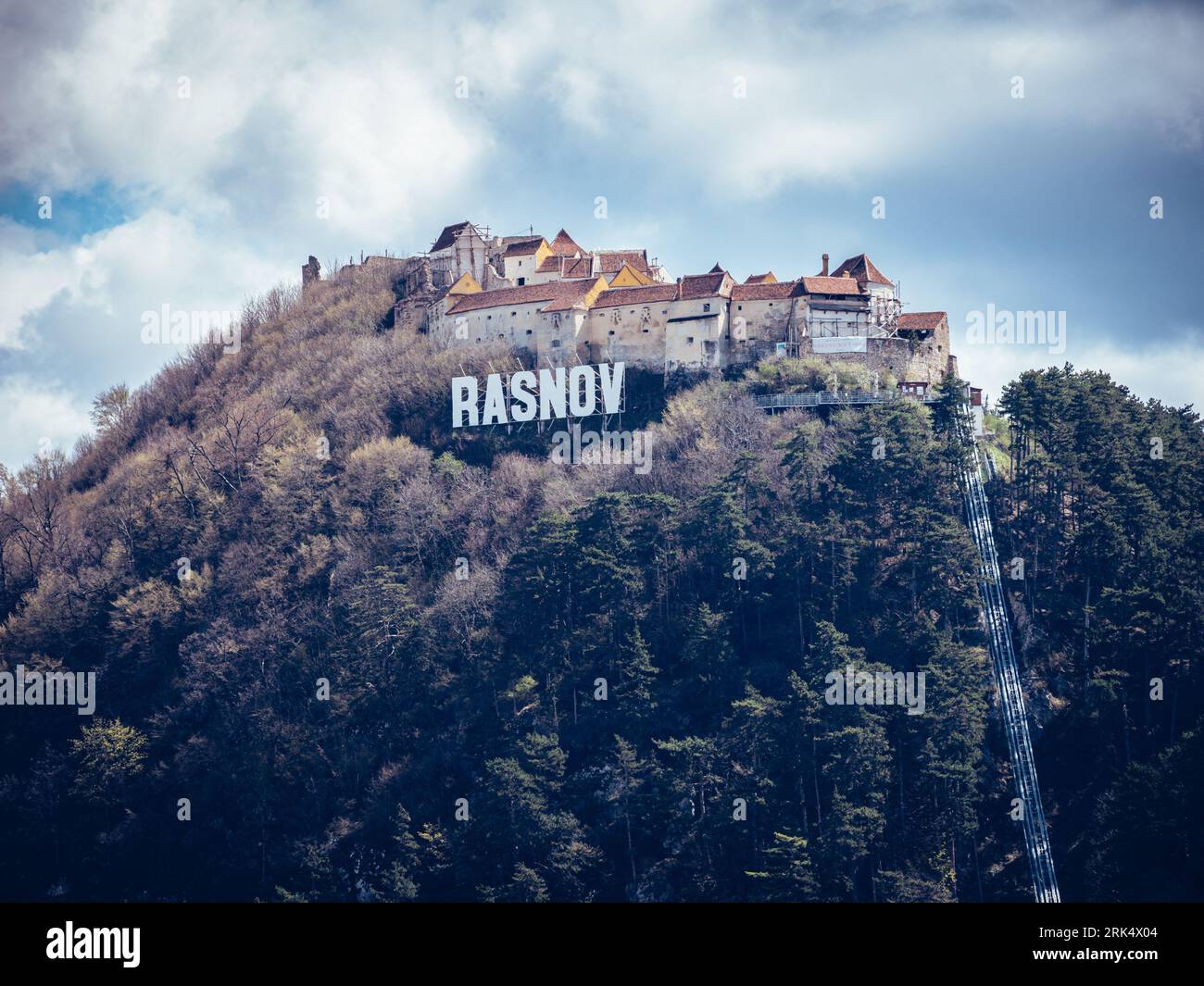 A majestic castle perched atop a mountain peak surrounded by lush ...