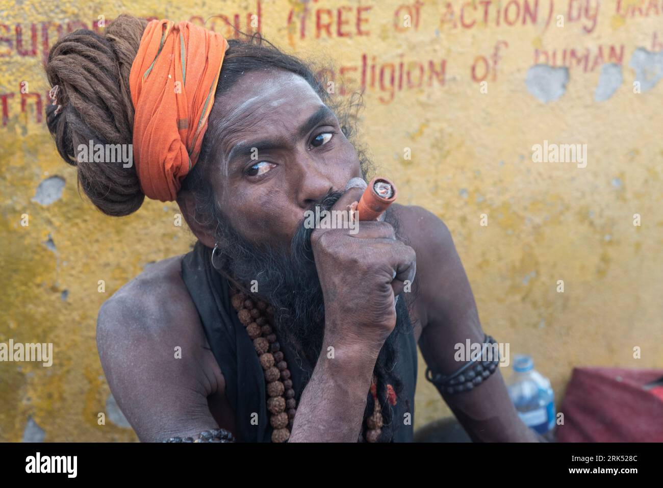 A Sadhu, a holy person in Hinduism, in Katmandu, Nepal, smoking marijuana Stock Photo