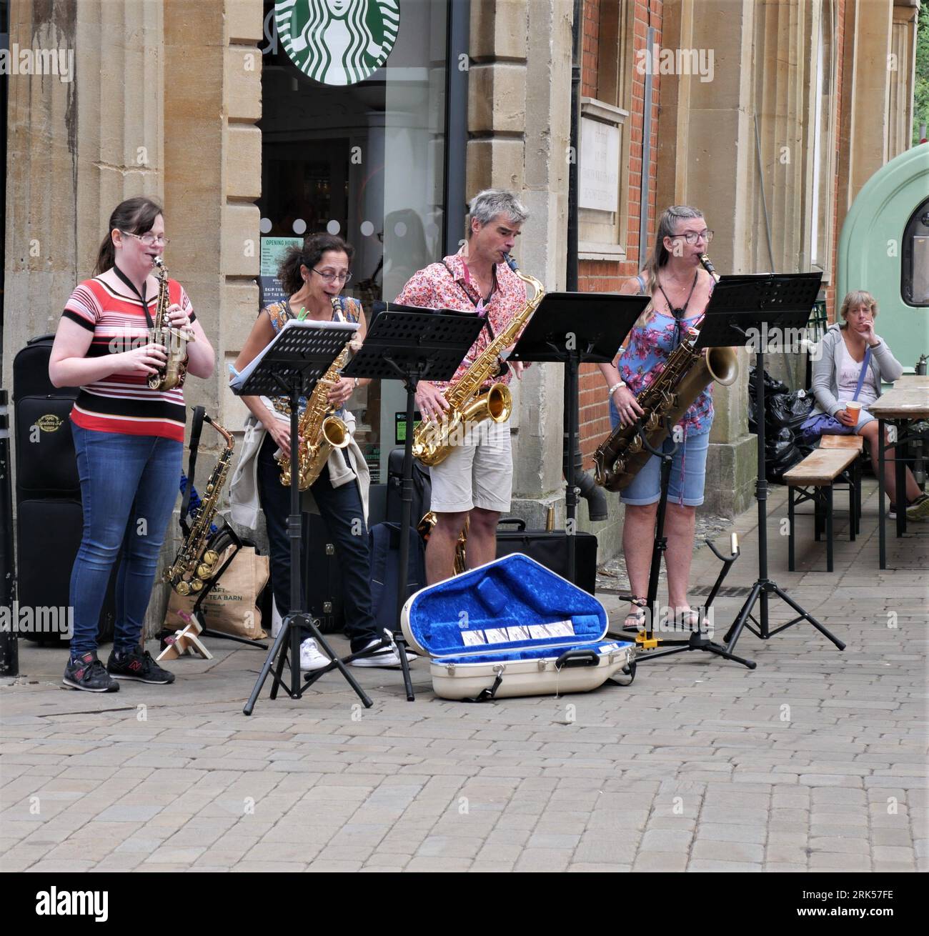 Group of saxophonists playing in Winchester Town Centre Stock Photo