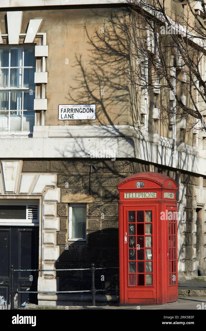 Old red telephone box in a London street scene around Farringdon area, North London, UKw Stock Photo