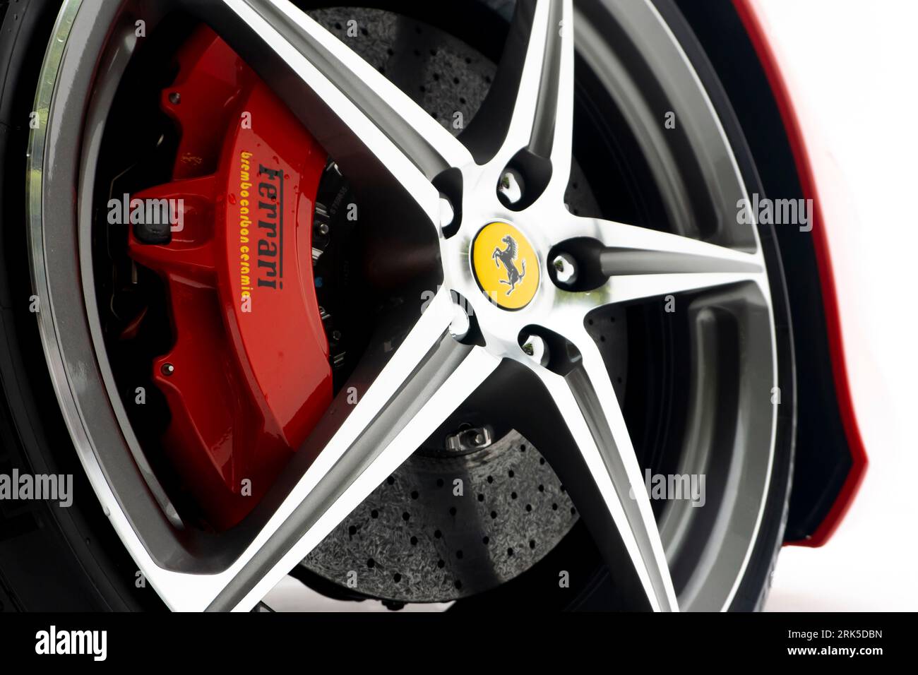 A closeup of a tire from a Ferrari automobile, showing its high