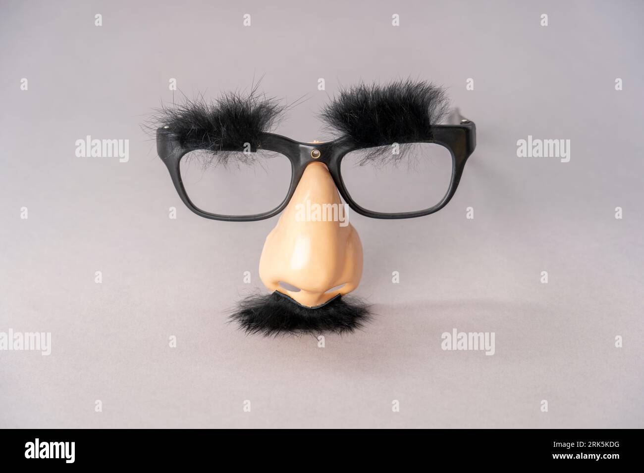 A black pair of glasses with a fake nose and black fuzzy mustache Stock Photo