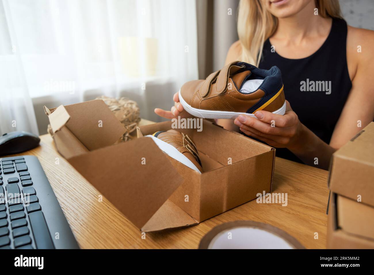 online footwear store owner, small business entrepreneur working at home office and preparing internet order parcel for delivery Stock Photo